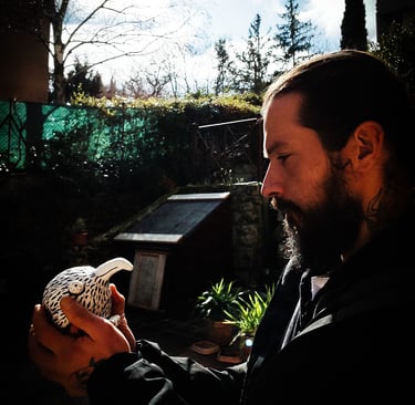 a man with a beard and a bird on his hand