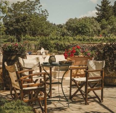 a table with chairs and a table with a vase at dourakis winery