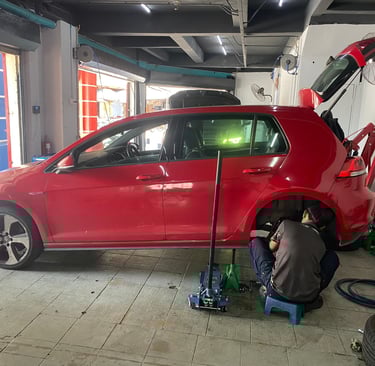 a man working on a car in a garage