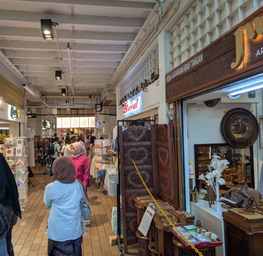 People browsing local artisan crafts and handmade souvenirs at The Central Market in Kuala Lumpur.