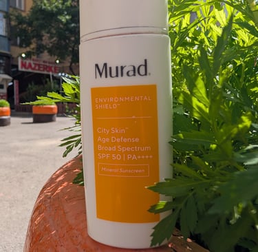 Murad Environmental Shield City Skin Age Defense Broad Spectrum SPF 50 mineral sunscreen bottle outdoors.