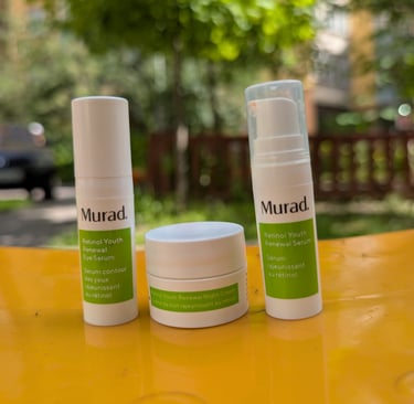 Murad Retinol Youth Renewal skincare set including eye serum, night cream, and face serum on a yellow surface.