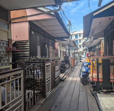Traditional wooden houses along a narrow boardwalk at new/mixed Jetties in George Town, Penang.