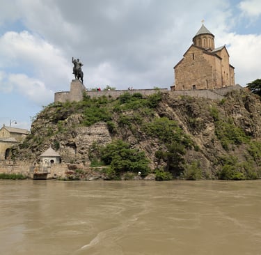 view of Metekhi Church of the Nativity of the mother of god across the Rura river in Tbilis georgia