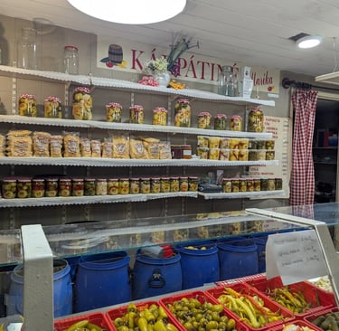 colorful and beautifully arranged homemade pickles in a vendor's display in the Great Market Hall