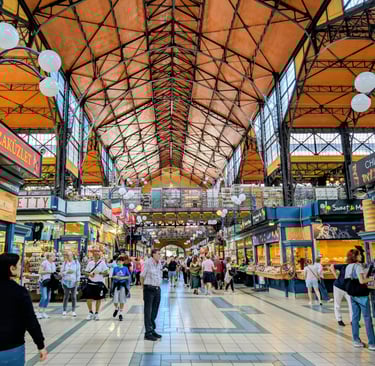 Tourists walking between the many stalls in the Central Market Hall, Budapest, Hungary.