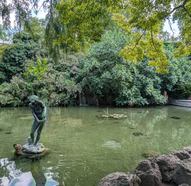 A statue of a boy in a Japanese pond on Margaret Island, Budapest, Hungary
