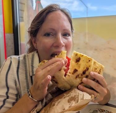 Samantha eatting a Pljeskavica a national dish of Serbia in Novi Sad, Serbia