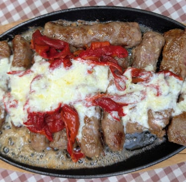 a sizzling pan of Čačak čevapi, sausage in Belgrade Serbia 