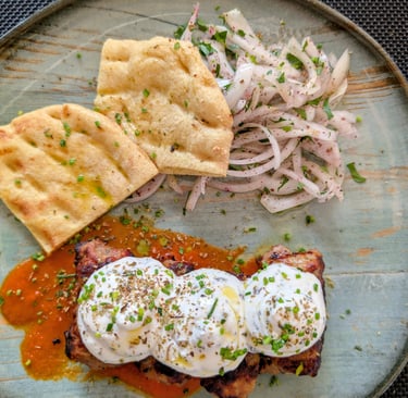 Giaurlou a greek dish made with mincedm eat topped with tomato sauce and yougurt in Thessaloniki, 