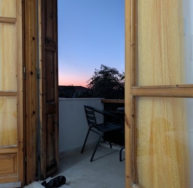 sunset view from the balcony of Karya apartment in Petra Greece