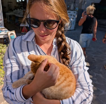 Samantha holding an orange cat on Lesbos island greece