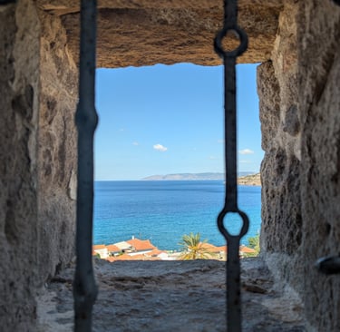 View from a window of the Aegean Sea from the Holy Church of the Virgin Mary Glykophilousa in Petra 