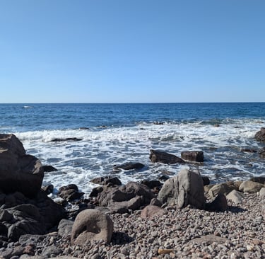 Waves crashing  on a rocky beach in Petra Greece