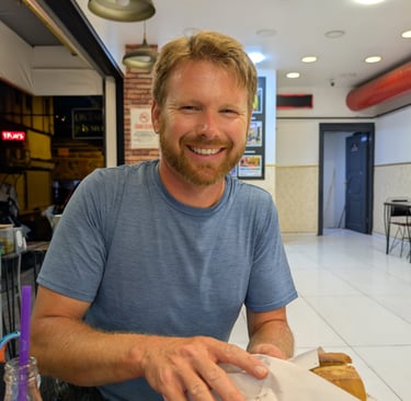 don holding a Kokorec sandwich from  Mis kokorec Kemeralti in Izmir, Turkey