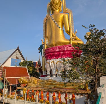 Giant golden Buddha statue and Reclining Buddha at Wat Khun Chan temple in Bangkok, Thailand.