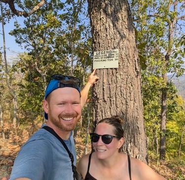 Don and Samantha standing in front of a small sign in Huai Na Dang Natiopnal Park, Thailand