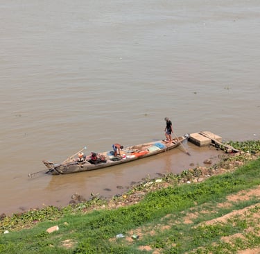 a wooden canoe on the banks of the Tonle Sap River in Phnom Penh, Cambodia