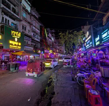 a neon lit night street scene in Phnom Penh, Cambodia