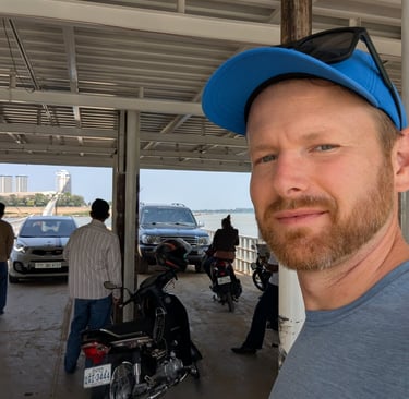 a selfie of Don on a river ferry crossing the Tonle Sap River in Cambodia
