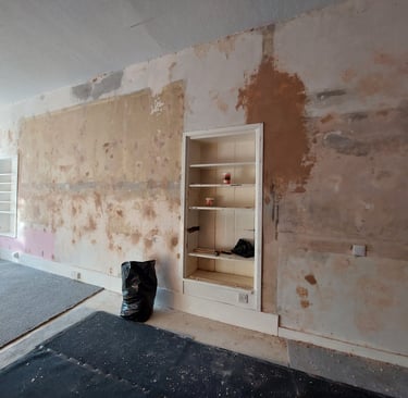 a wall during renovations with holes filled before papering