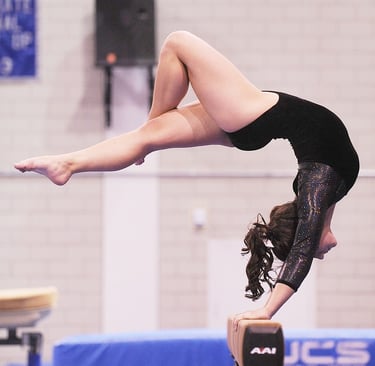 Imagen de una persona practicando movimientos de gimnasia artística, como equilibrios o saltos sobre