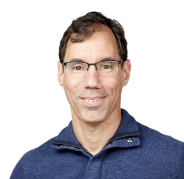 Neal Moore, a man in a blue sweater and glasses