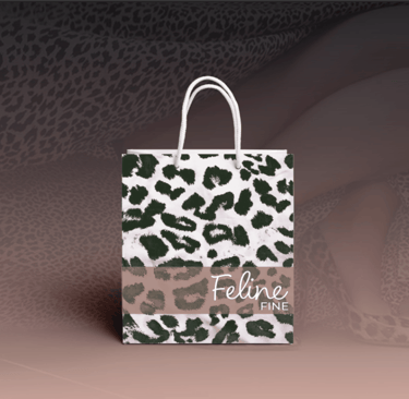 Feline Fine branded tote bag with stylish logo and minimalist fashion design.