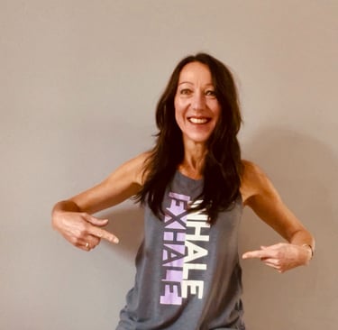 Lady wearing a T-shirt which says Inhale Exhale on it