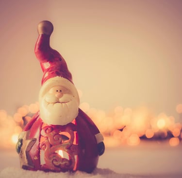 An image of Santa Claus flying through the night sky with his reindeer, delivering gifts to children