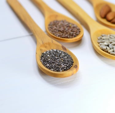 A variety of seeds including chia, flax, pumpkin, sunflower, and sesame seeds