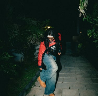 A person walks forward from a darker space into a brighter area, suggesting movement and transition 