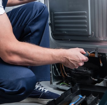 a man in a white shirt is fixing a machine