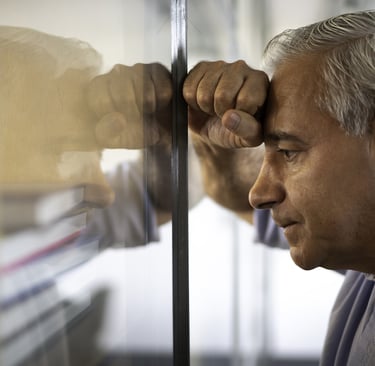 a man in a blue shirt is looking at something