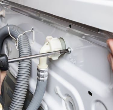 a person is fixing a dishwasher in a kitchen