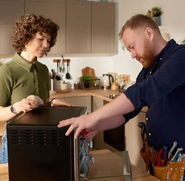 a man and woman standing in a kitchen