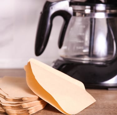a coffee maker with a paper bag on a table