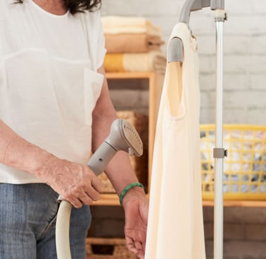 a woman in a white shirt is holding a vacuum
