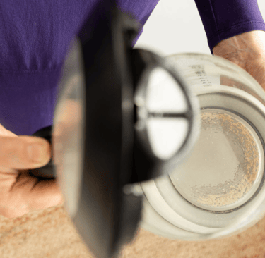 a person holding a coffee potted in a potted pot