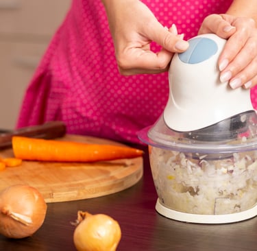 a woman is holding a blender in her hands