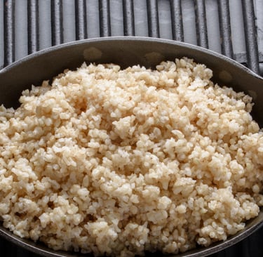a bowl of rice with a spoon and a fork