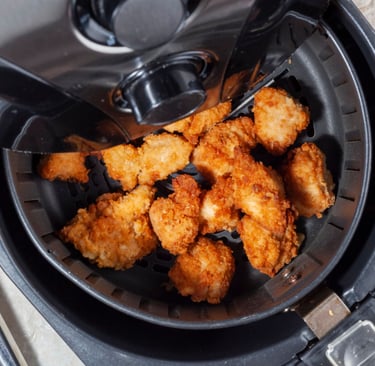 a fryer with chicken nuggling in it