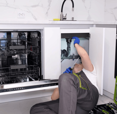 a man in a kitchen with a dishwasher and a dishwasher