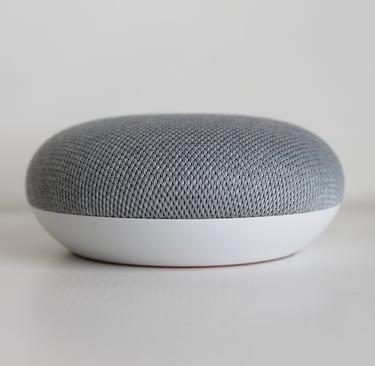 a google homepod speaker with a grey and white background