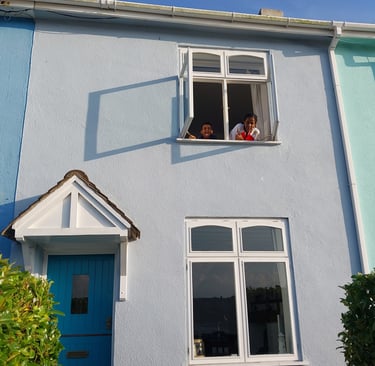 Familys enjoying kids looking out the colourful Devon houses
