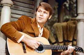 Glen Campbell singing on an old house porch