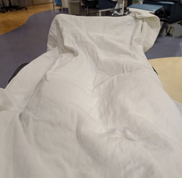 Greg Rowland at Duke Health covered with a warm blanket