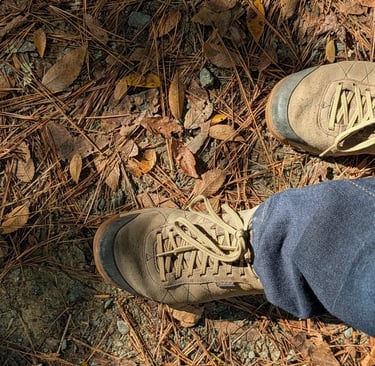 Greg Rowland hikung. Close up photo of his boots.