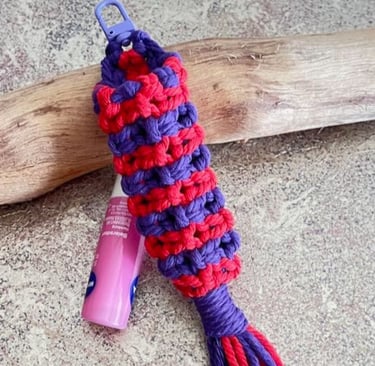 handmade macrame chapstick holder in bright red and purple colours