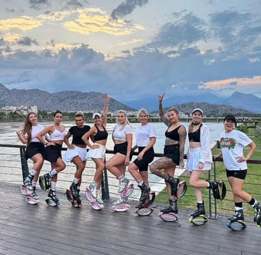 a group of women standing on a deck with kangoo jump boots